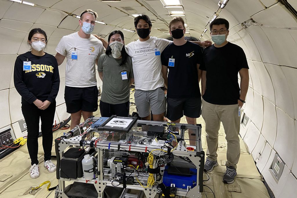 MAE research team in plane installing equipment