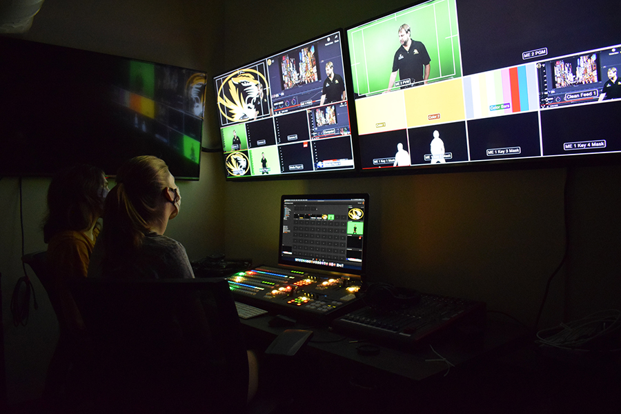 Student in masks sit in front of screens in the Interactive Digital Environments Lab.