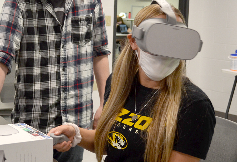 A student uses VR goggles.