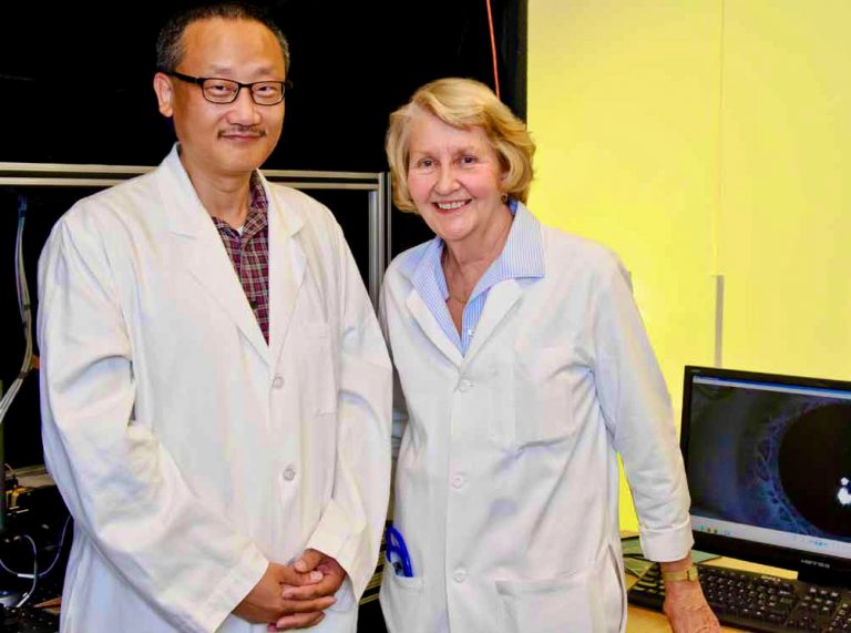 Gary Yao and Judith Miles pose for a photo in their lab