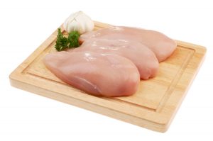 Raw chicken on a cutting board.