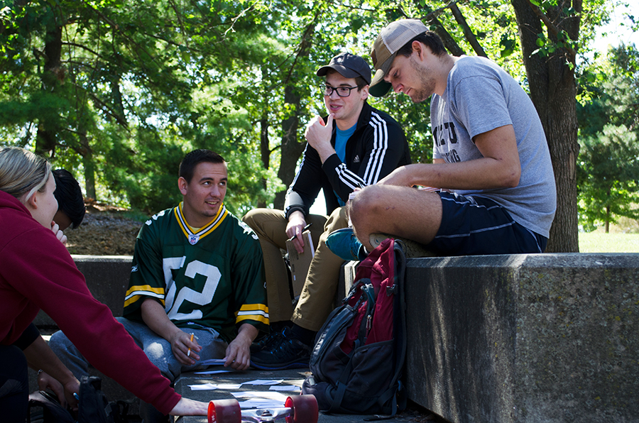 Students sitting together on campus, discussing homework.