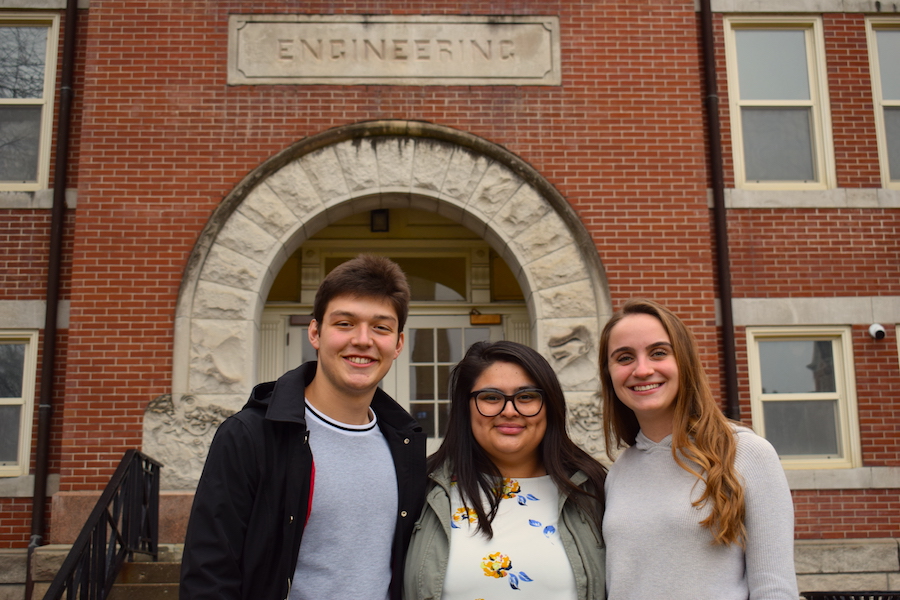 Three Mizzou Engineering students pose together in front of the east entrance to Lafferre Hall.