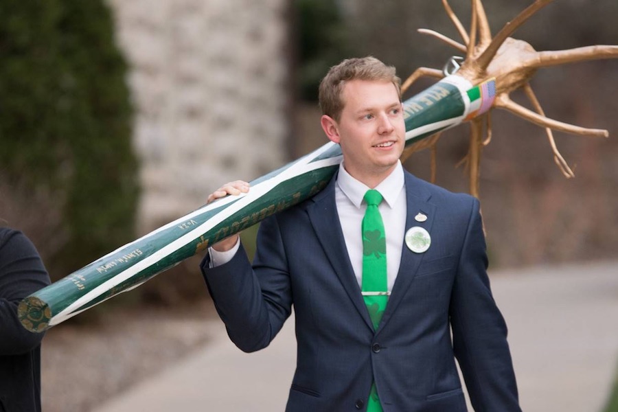 Hagan, in a suit with a green tie, carries his shillelagh.