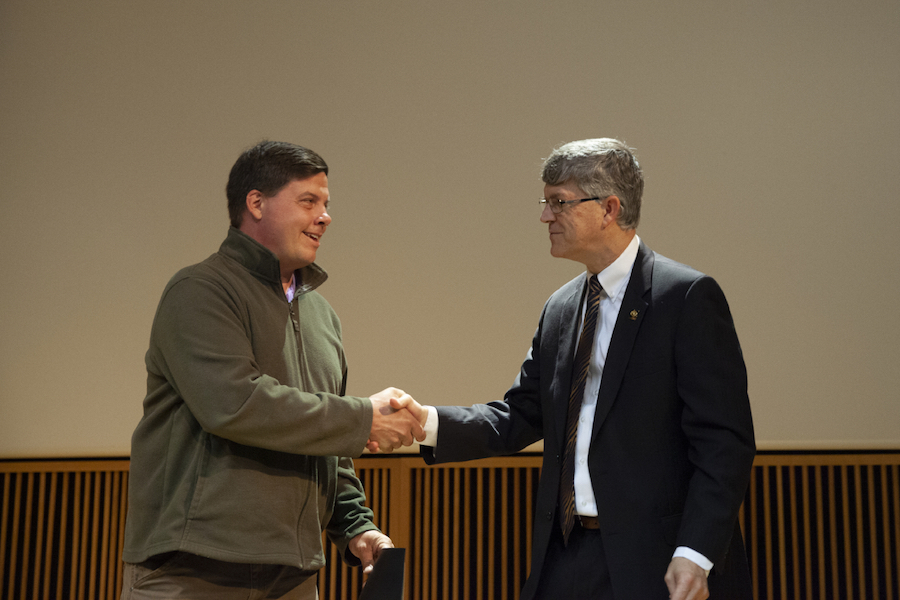Jim Spain, Vice Provost of Undergraduate Studies, congratulates Ferris Pfeiffer, assistant professor in biomedical, biological and chemical engineering, for receiving the Research Mentor of the Year Award.