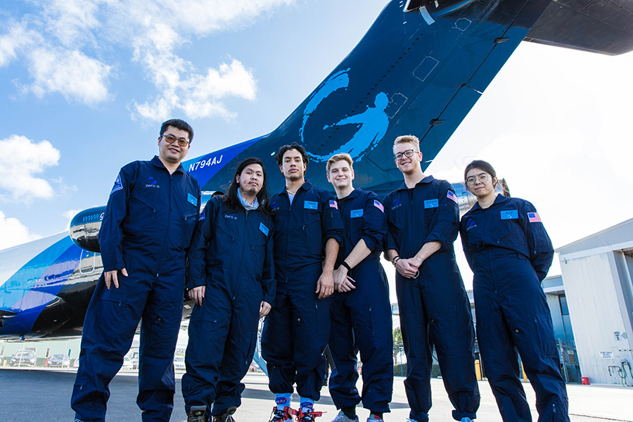 Group of people in front of a plane