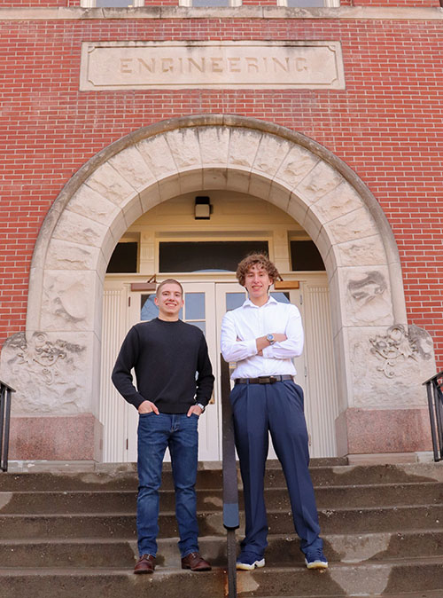 Two men in front of Engineering building.