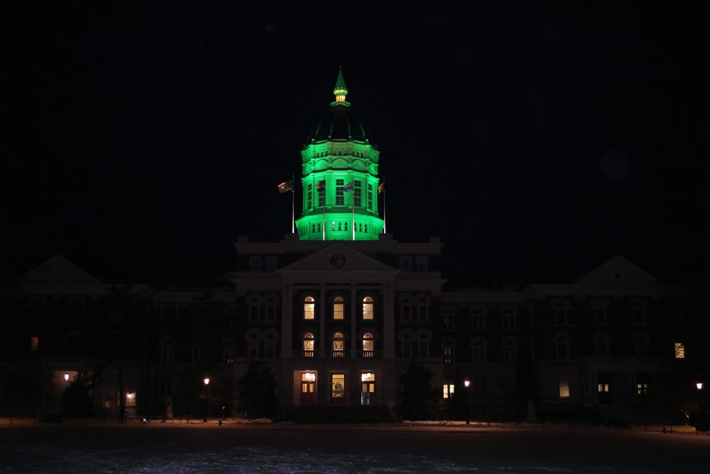 Image of Jesse Hall at night with green dome