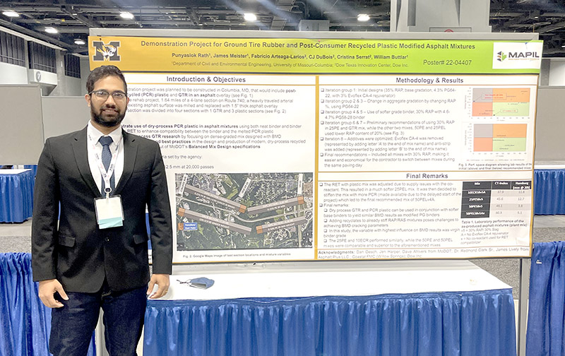 Man standing in front of research poster.