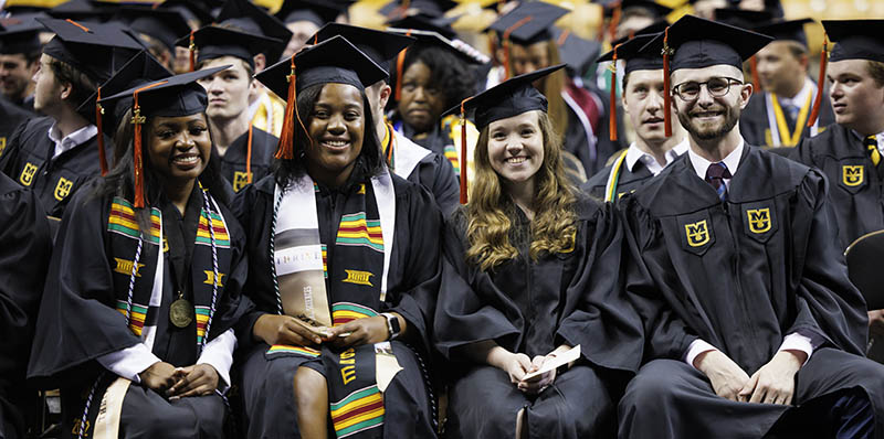 Graduates smiling at camera