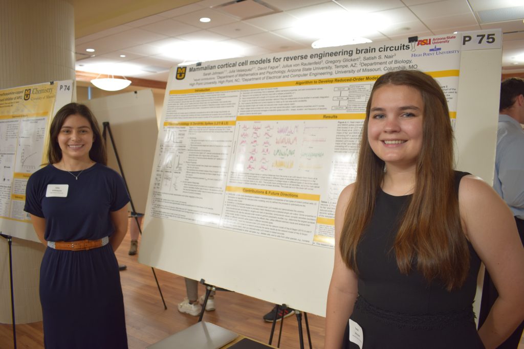 Sarah Johnson and Julia Velasquez posing with their research poster