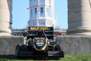 Formula car in front of the columns and Jesse Hall