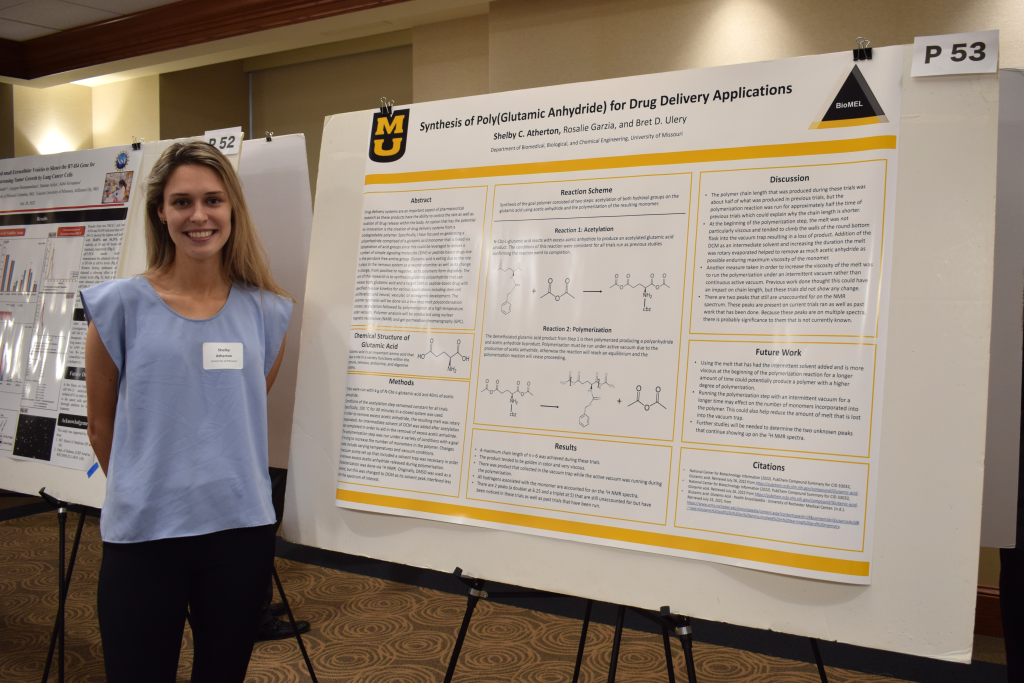 Shelby Atherton posing with her research poster