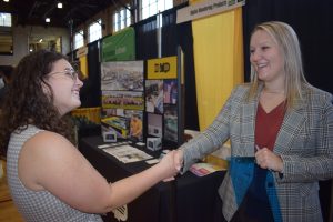 An engineering student shakes hands with a recruiter from one of 226 employers at the fair.
