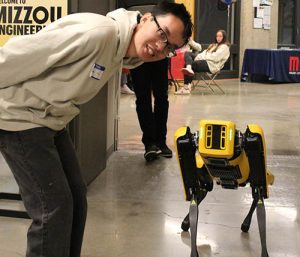 Johnson Luu with Spot the doglike robot from Boston Dynamics.