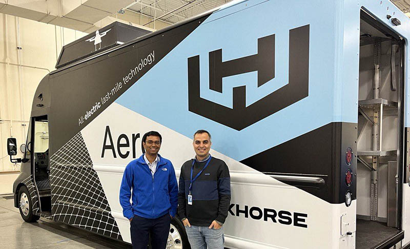 Two men in front of Workhorse branded truck