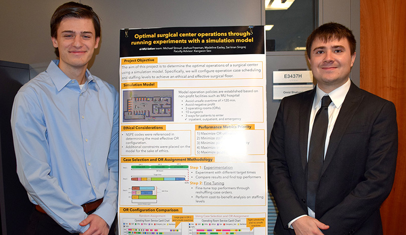 Joshua Freeman and Michael Stroud in front of their research poster.