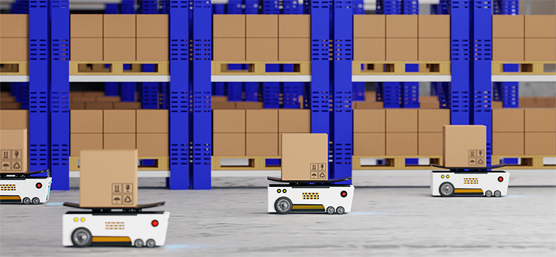 Photo of five small mobile robots carrying boxes in manufacturing plant