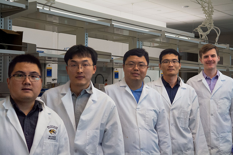 Five researchers pose in the lab