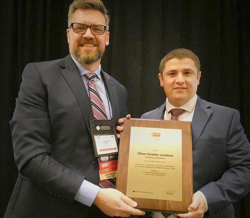 Two men holding award