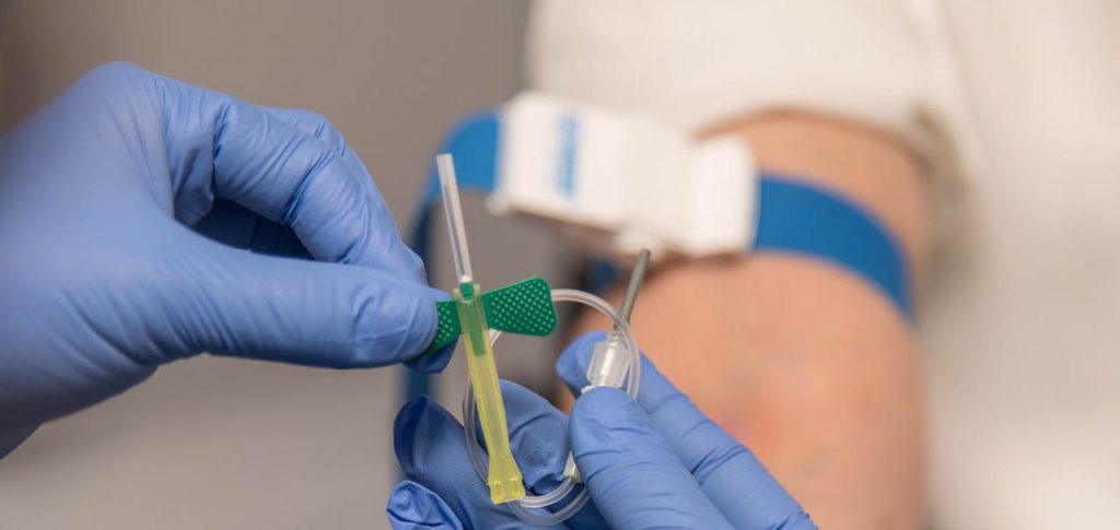 Surgical hands taking blood donation