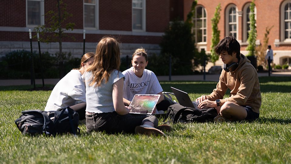 Students sitting outside studying