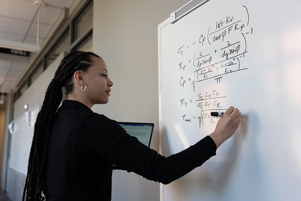 Student writing on a whiteboard