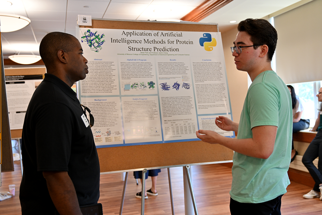 Nolan Park (right) presenting his research to Reginald Rogers