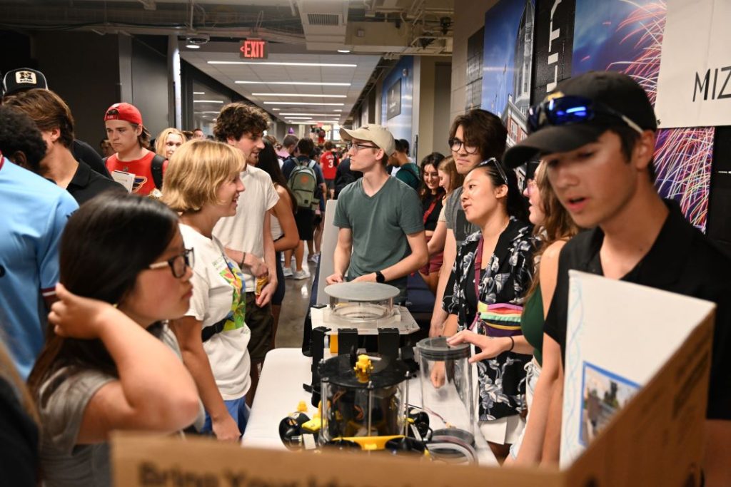 Students learn about a club at the BBQ