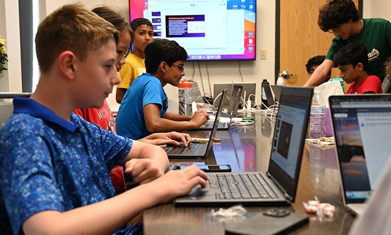 Students work on computers.