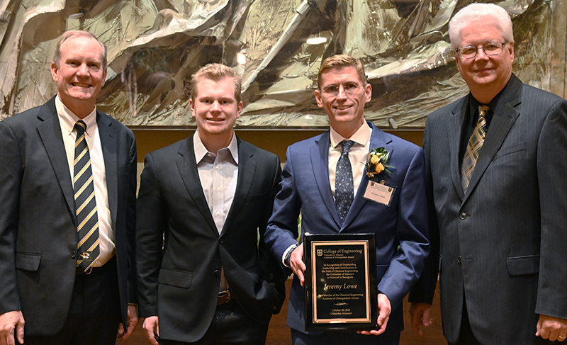 Four people including Jeremy Lowe with award