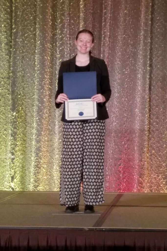 Emma McDougal with an award