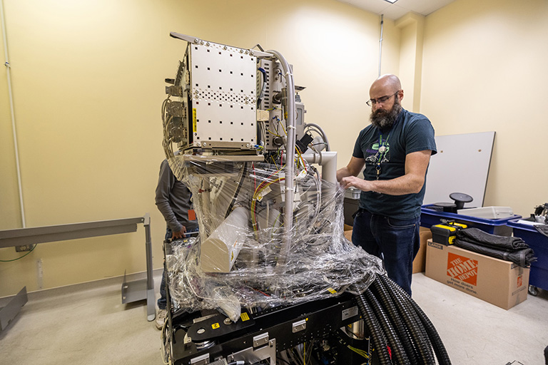 David Stalla, a senior scientist with the University of Missouri Electron Microscopy Core, unwraps the scanning electron microscope in its new location at the MU Research Reactor.