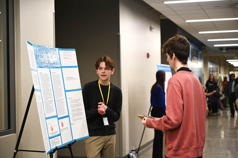 high school student presenting research to judge