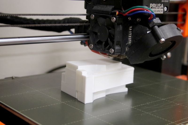 3D printer printing a smaller model of the new hospital