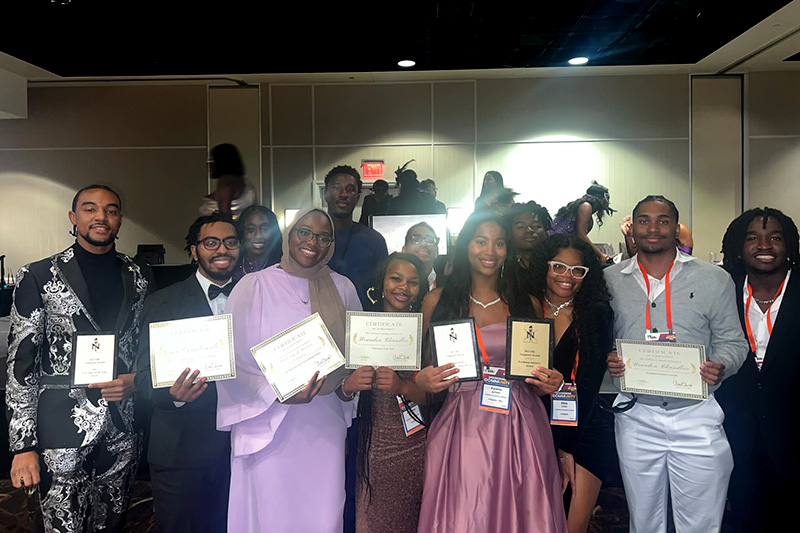 Mizzou National Society of Black Engineers members holding awards from the 2023 Fall Regional Conference