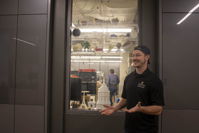 Hunter Darnell Leading tour, standing in front of the 3D Printing Research and Experiences Lab