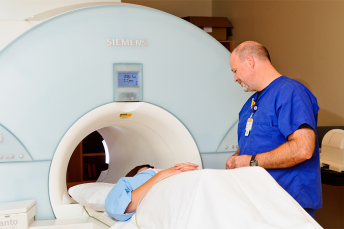 Photo of a MRI tech with a patient