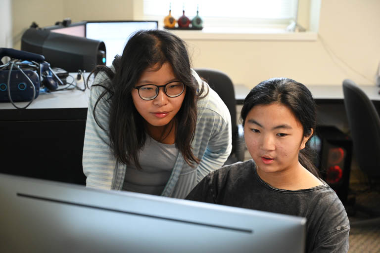 Two people at computer at one of Mizzou Engineering's NSF REUs