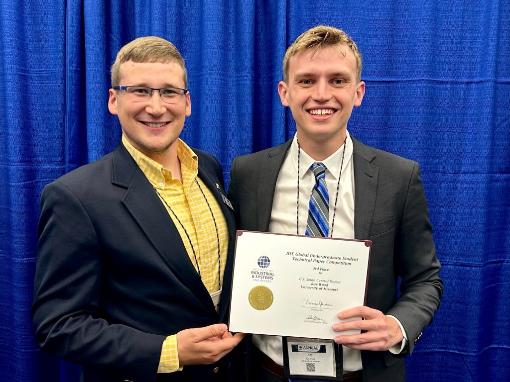 Ray Wood (right) with Emmett Hull; holding award for one of two third place finishes in IISE research competitions.