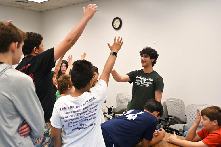 students and instructor at programmable robotics camp