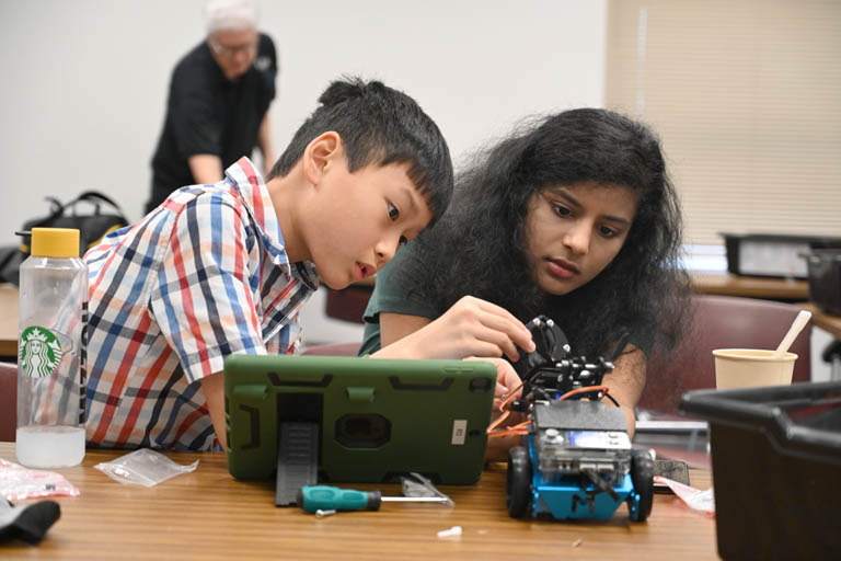 student and instructor at programmable robotics camp