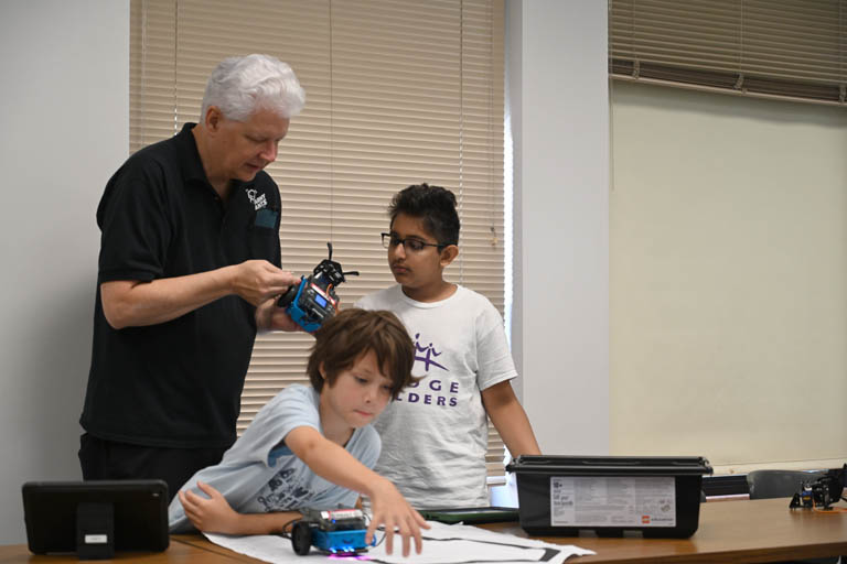 students and instructor at programmable robotics camp