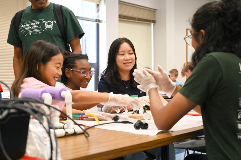 students and instructor at underwater robotics camp