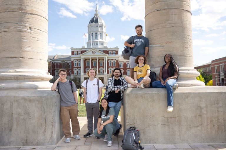 Students smiling in front of the Columns and Jesse Hall