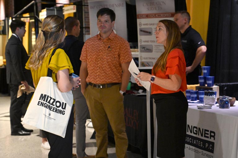 Student speaking to employer at fall 2024 career fair