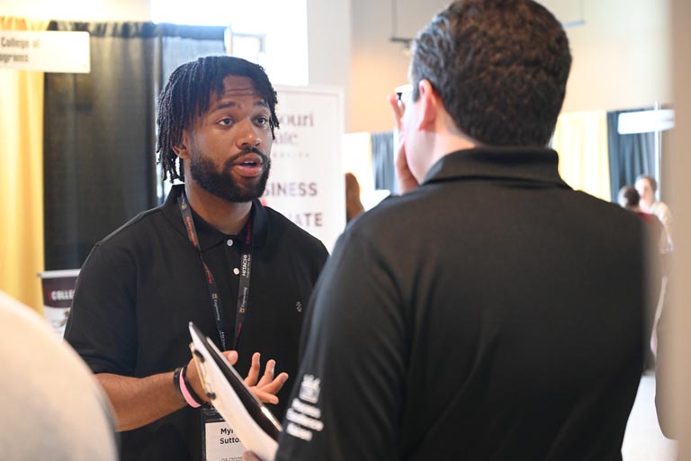 Student speaking to employer at fall 2024 career fair