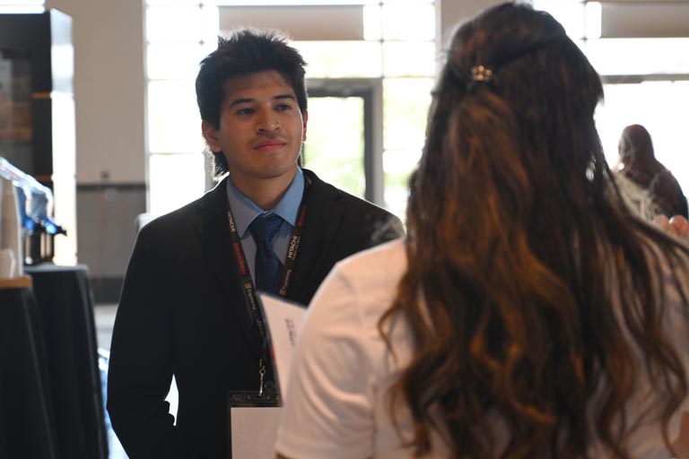 Student speaking to employer at fall 2024 career fair