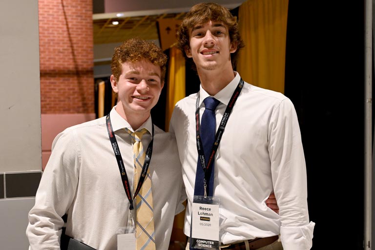 Two students posed, smiling at career fair