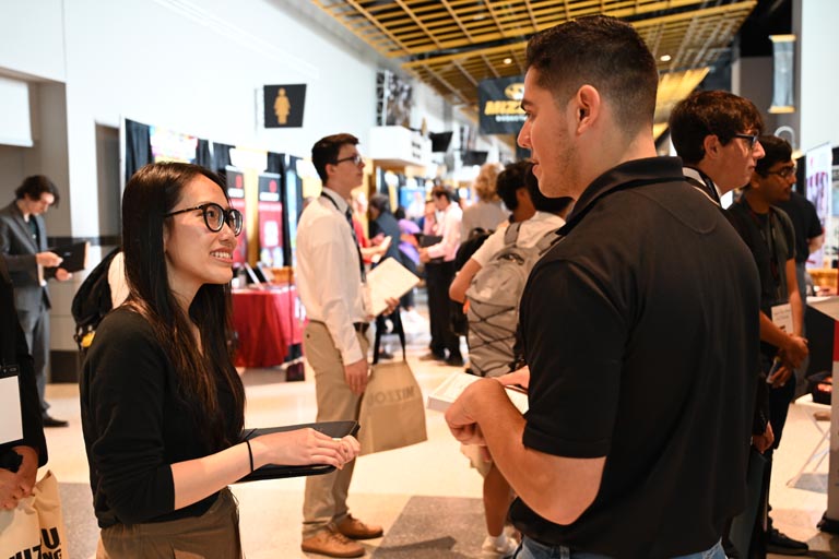 Student speaking to employer at fall 2024 career fair